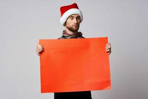 handsome man in a christmas hat with Red mockup poster isolated background photo