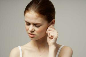 sick woman poor hearing disorders in white t-shirts studio treatment photo