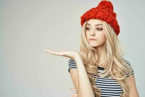 beautiful woman in fashionable clothes Red Hat light background Lifestyle photo