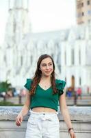 Beautiful tourist girl at the Ortiz Bridge with La Ermita church on background in the city of Cali in Colombia photo