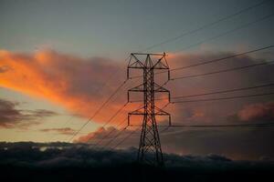 Power tower against a dramatic beautiful sunset sky photo