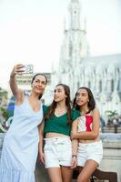 Tourists taking a selfie at the Ortiz Bridge with La Ermita church on background in the city of Cali in Colombia photo