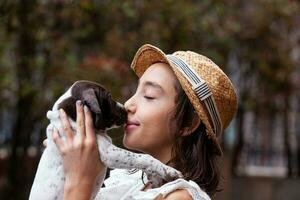 Beautiful young girl having fun with her small French Braque puppy photo