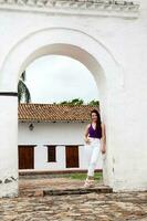 Beautiful young woman at the historical La Merced Church located in the Cali city downtown in Colombia photo