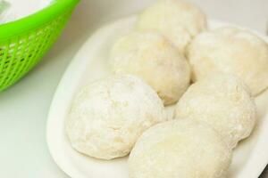 Preparation steps of traditional Colombian dish called stuffed potatoes. Stuffed potatoes covered with flour photo