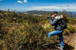 Young woman exploring the nature of a beautiful paramo at the department of Cundinamarca in Colombia photo