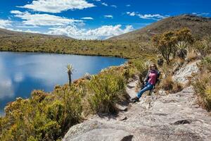 Young woman exploring the nature of a beautiful paramo at the department of Cundinamarca in Colombia photo