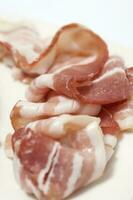 Closeup of raw pork bacon slices photo