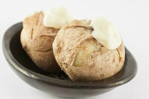 Traditional Colombian cooked potatoes called papas saladas topped with mayonnaise isolated on white background photo