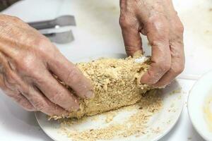 Breading a cordon bleu. Adding crumbled cracker photo
