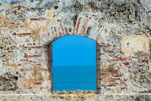 Ocean seen through the embrasure of the city walls in the Cartagena de Indias photo