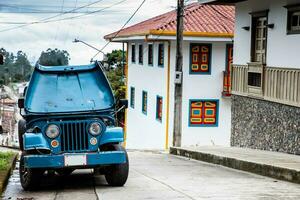 Traditional off-road vehicle parked at a beautiful street in the small town of Salento located at the region of Quindio in Colombia photo