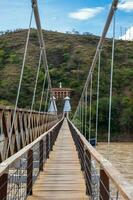 The historical Bridge of the West a a suspension bridge declared Colombian National Monument built in 1887 over the Cauca River photo