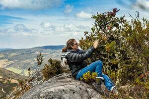 Young woman exploring the nature of a beautiful paramo at the department of Cundinamarca in Colombia photo