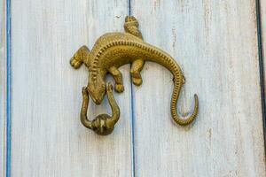 Door knocker Iguana shaped at the walled city of Cartagena de Indias photo