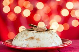 Traditional Colombian natilla on christmas red background photo