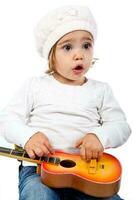 Beautiful little blonde girl playing with a toy guitar photo