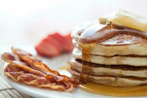 Pancakes with honey, bacon and strawberries photo