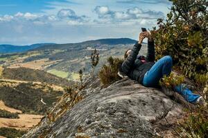 Young woman exploring the nature of a beautiful paramo at the department of Cundinamarca in Colombia photo