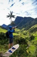 Tourist taking pictures at the beautiful Valle de Cocora located in Salento at the Quindio region in Colombia photo