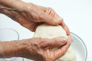 Colombian arepa dough preparation. Flatten the dough balls a bit with your hands to form the arepa typical shape photo