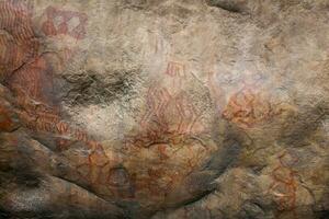 Prehistoric paintings on rock known as petroglyphs in Colombia photo