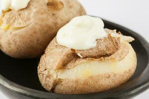 Traditional Colombian cooked potatoes called papas saladas topped with mayonnaise isolated on white background photo