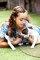 hermosa joven niña teniendo divertido con su pequeño francés braque cachorros foto