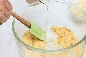 Traditional Colombian Arepa de Choclo Preparation. Adding milk to prepare sweet corn bread photo