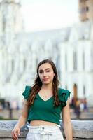 Beautiful tourist girl at the Ortiz Bridge with La Ermita church on background in the city of Cali in Colombia photo