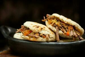 Colombian arepa filled with shredded beef photo
