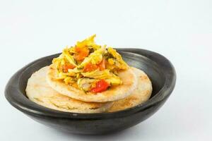 Traditional Colombian arepa topped with chicken breast photo