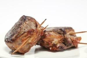 Closeup of Fillet Mignon medallions on white background. photo