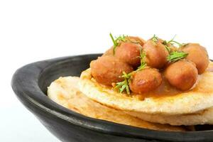 Traditional Colombian arepa topped with beans photo