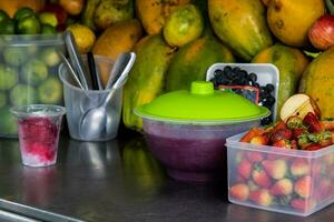 Preparation of a traditional sweet water ice with fruits called cholado in the city of Cali in Colombia photo