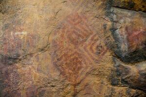 Prehistoric paintings on rock known as petroglyphs in Colombia photo