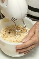 Mixing cookies dough with a hand mixer photo