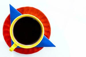 Cup of Colombian coffee and the colors of the Colombian flag isolated on white background photo