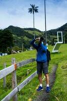 Tourist taking pictures at the beautiful Valle de Cocora located in Salento at the Quindio region in Colombia photo