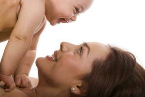 Happy beautiful young mother and her baby girl on white background photo