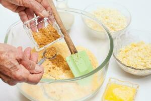 Traditional Colombian Arepa de Choclo Preparation. Adding sugar to prepare sweet corn bread photo