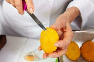 Preparation of the traditional dish from the Caribbean Coast in colombia called Arepa de Huevo or egg arepa photo