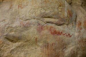 Prehistoric paintings on rock known as petroglyphs in Colombia photo