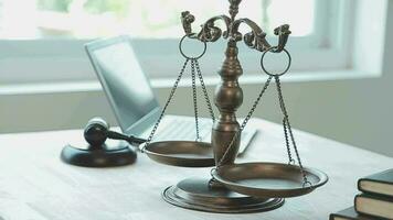 Justice and law concept.Male judge in a courtroom with the gavel, working with, computer and docking keyboard, eyeglasses, on table in morning light video