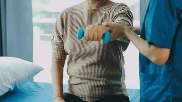 young asian physical therapist working with senior woman on walking with a walker video