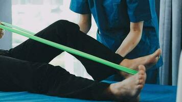 young asian physical therapist working with senior woman on walking with a walker video