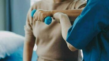 young asian physical therapist working with senior woman on walking with a walker video