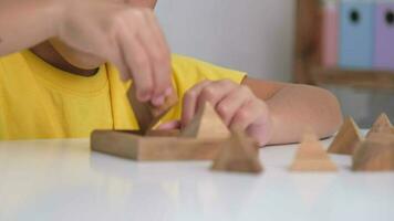 ásia fofa pequeno menina jogando com de madeira brinquedo quebra-cabeças enigma pirâmide em mesa. saudável crianças Treinamento memória e pensamento. de madeira quebra-cabeças estão jogos este aumentar inteligência para crianças. video