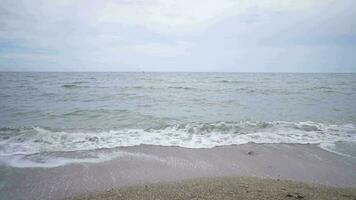 Sea scape with brown and white sand with cloudy vibes. The footage is suitable to use for relaxion video background and travel content media.