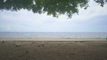 Sea scape with brown and white sand with cloudy vibes. The footage is suitable to use for relaxion video background and travel content media.